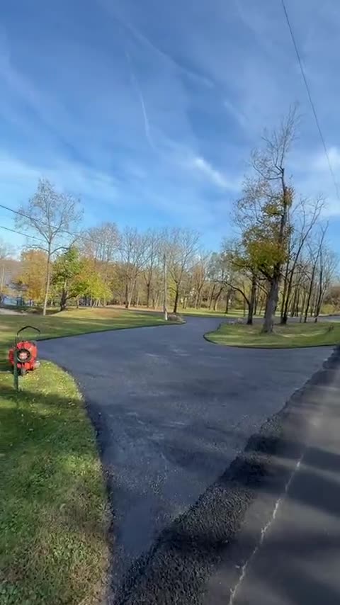 Long new driveway curving through a yard