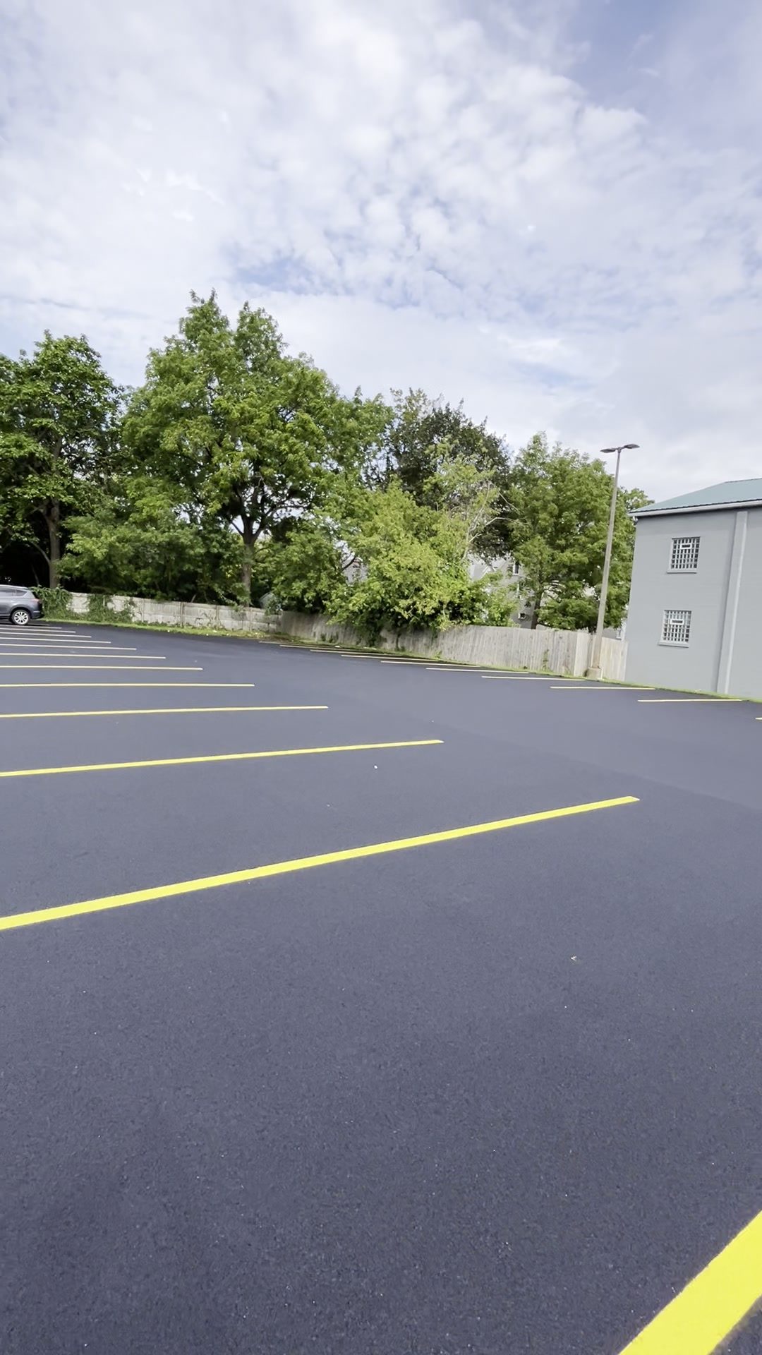 Parking lot with fresh black surface and new yellow lines